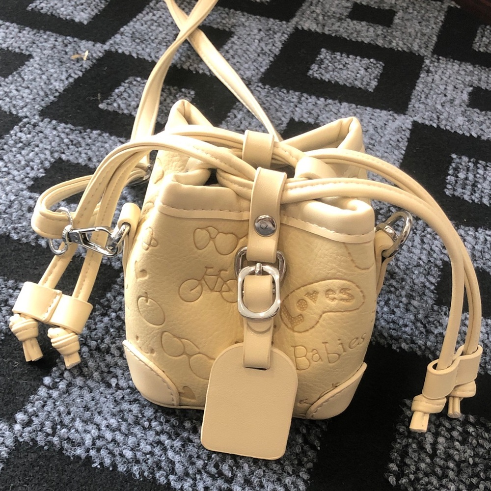 Cream Drawstring Mini Bucket Bag with Embossed Motif